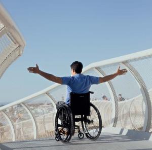Man arms stretched sitting on Wheelchair
